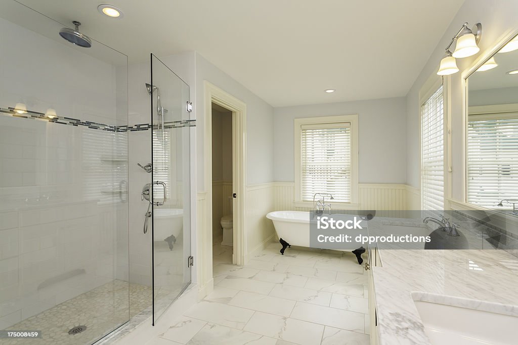 Large Bathroom with Enclosed Glass Shower Horizontal shot of a luxury master bathroom with large shower and double sink countertop.  Shower Stock Photo