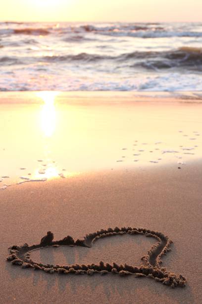 istock heart in the sand at sunset 1750088044