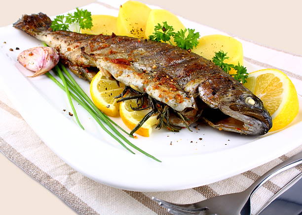istock Grilled whole trout with potato, lemon and garlic 175009099