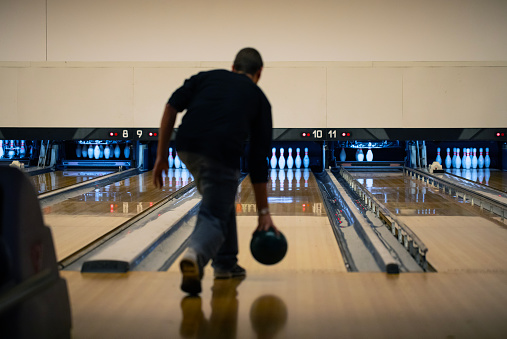 Rear View on Adult Man Bowling.