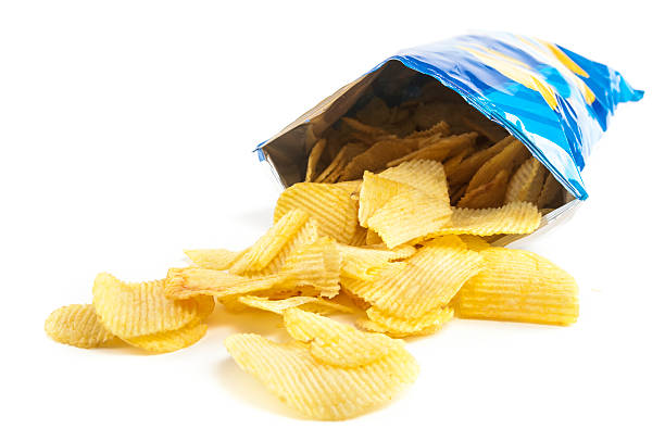 crisps heap of potato crisps on white background BAG OF CHIPS stock pictures, royalty-free photos & images
