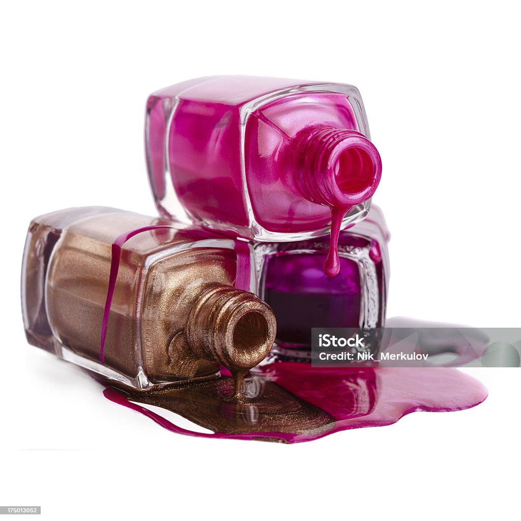 Bottles with spilled nail polish Bottles with spilled nail polish over white background Beauty Stock Photo