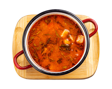 Pot of Hungarian goulash on brown background