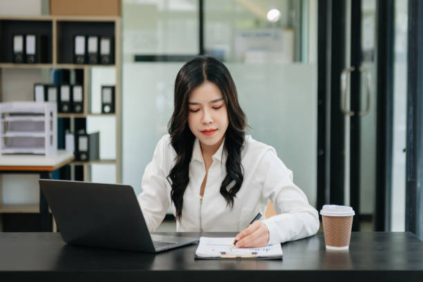 istock Asian businesswoman working in the office with working notepad, tablet and laptop documents 1750147653