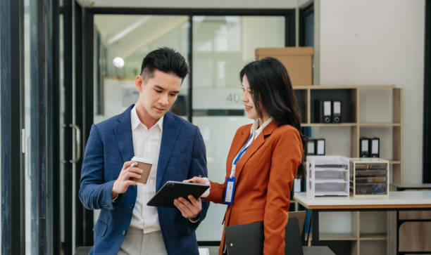 istock Two business workers talking on the smartphone and using laptop at the office. 1750147986