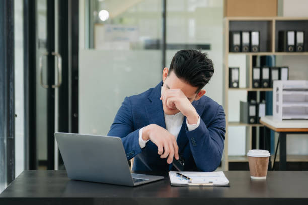 istock Asian businessman is stressed, bored, and overthinking from working on a tablet at the modern office. 1750148591