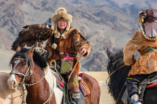 Eagle huntress winner at the Sagsai Golden Eagle Festival held on 17th-18th September 2023, near the small town of Sagsai, in the Bayan-Ulgii province of Western Mongolia. Set in the Altai Mountain range, the nomadic eagle hunters, dressed in traditional fur and embroidered clothing, gather to compete with their eagles, in various competitions that show the skill and bond between the hunter and their eagle.