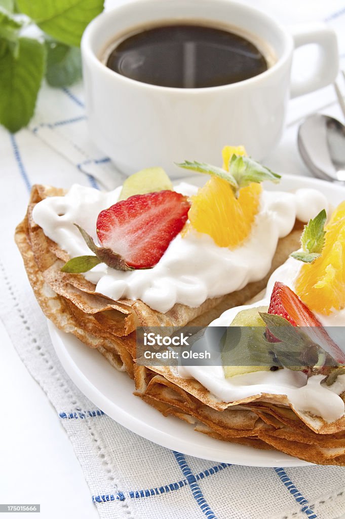 Crepes with soft cream Crepes with soft cream, strawberries, kiwi, oranges and mint Appetizer Stock Photo
