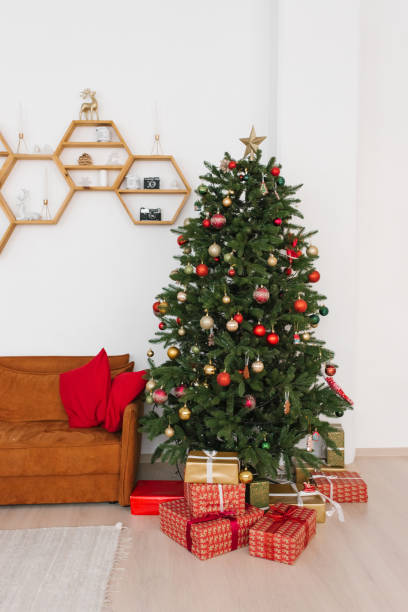 istock Christmas tree in a bright living room near a red sofa with red pillows 1750177513