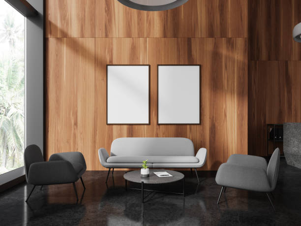 istock Dark wooden office waiting room with sofa and posters 1750179789