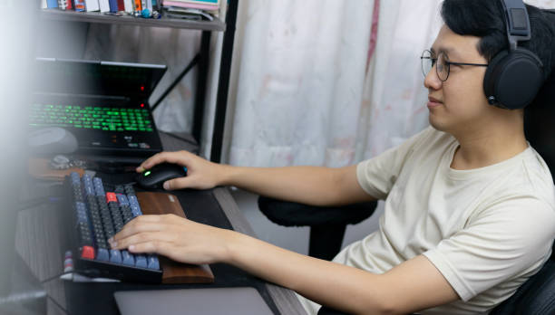istock A happy man gamer playing video games on computer. Fun and entertainment hobby technology in a bright daylight room 1750183529