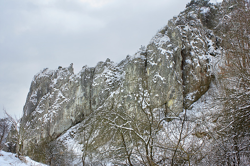 winter landscape with snow-covered rocks. Mountains in winter on a cloudy day