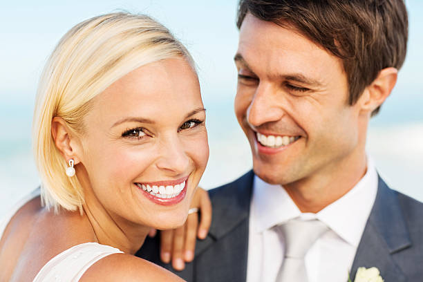 istock Loving Bride With Groom Looking At Her On Beach 175020363
