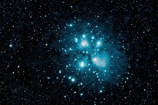A stunning deep space image showcasing the Pleiades, or the Seven Sisters, in unparalleled detail. The rich blues and surrounding nebulosity are brought to life through the art of astrophotography, revealing the beauty and mysteries of this beloved star cluster.