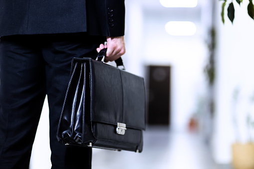 Unrecognizable Businessman holding a briefcase walking