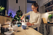 Teenage girl baking cake for Christmas