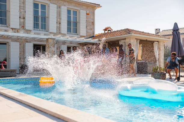 istock A Person Jumping Into A Pool At A Pool Party And Splashing Everywhere 1750210749