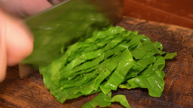 chef cuts sorrel with a knife