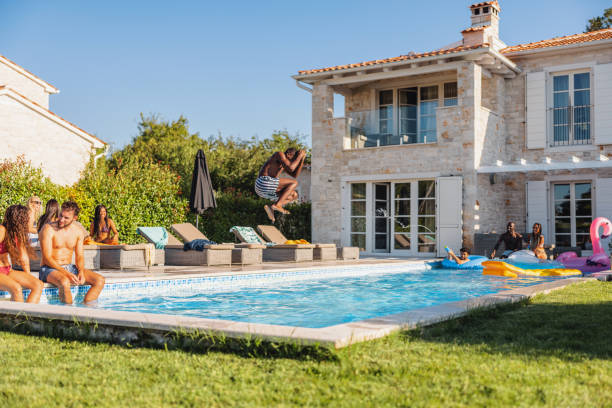 istock A Black Male Jumping Into The Pool During A Fun Pool Party 1750225467