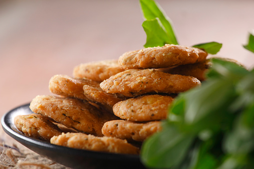 Methi mathri is a popular Indian snack that is typically made from flour, spices, and fenugreek leaves (methi).
