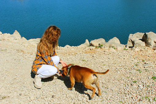 Beautiful idylic photo of a girl with dog. Getting away from city and enjoying nature.