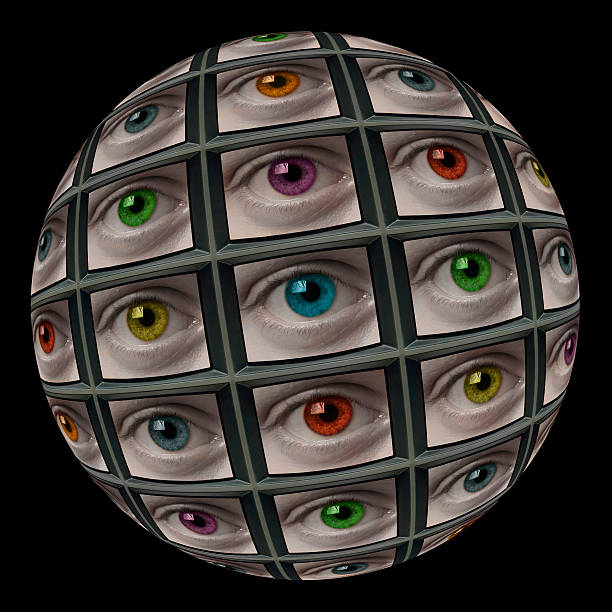 Sphere of video screens showing multi-colored eyes. On black background.