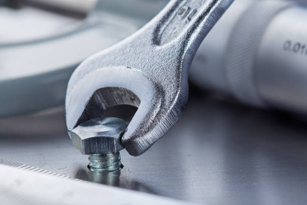 istock Wrench tightens bolt in steel billet. Spanner, bolt, screw and nuts. 1750234582
