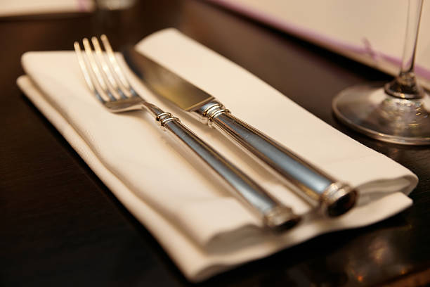 istock Fork, knife and napkin on restaurant table, warm light 175025369