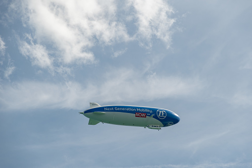 Mainau, Germany, July 20, 2023 Zeppelin is flying overhead the lake of Constance