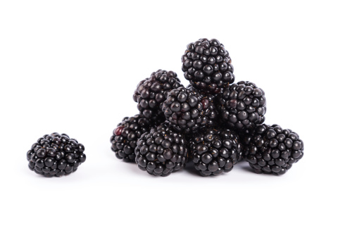 fresh forest fruits - blackberries on white background