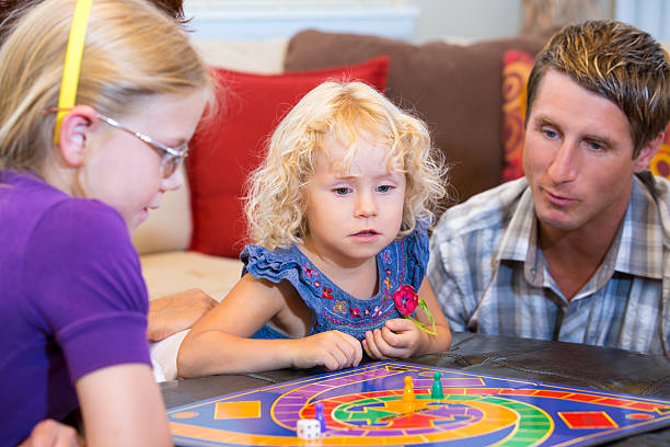 istock Little girl contemplating her next game move 175030339