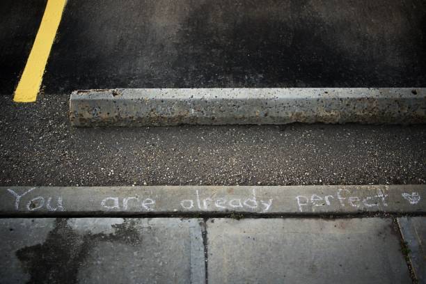 istock a sign written on a sidewalk with a street light in the background 1750305907