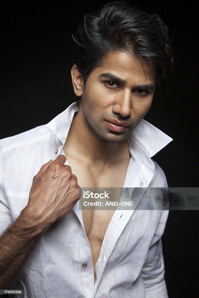 Cool and confident young man Cool and confident young man with unbuttoned shirt Adult Stock Photo