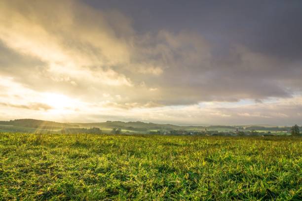 istock the sun peeks through the clouds to light up a field 1750339893