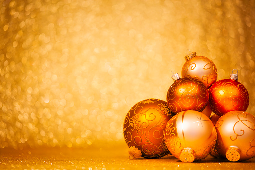 Golden Christmas Baubles on glitter background