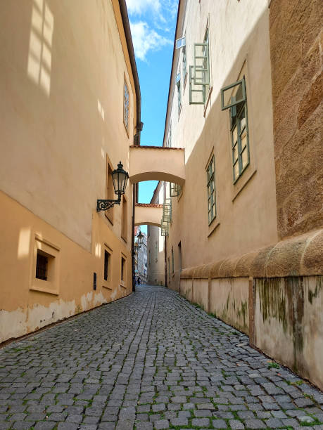 istock A passage in the form of a cobblestone sidewalk between two ancient buildings with windows in the old town 1750393354