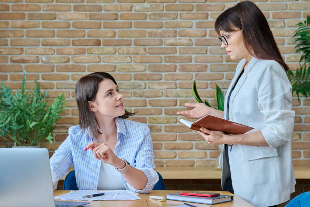 istock Two businesswomen talking and discussing in office 1750397699