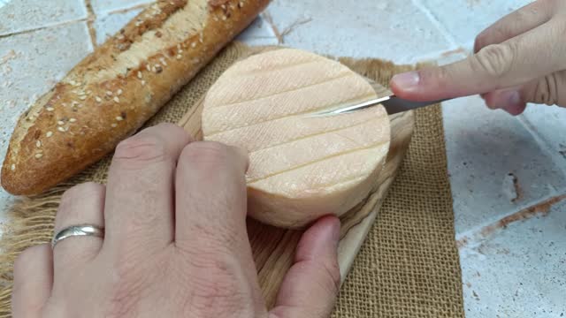 French cheese: Munster, close-up, on a cutting board