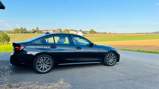 Marbach, Germany - October, 17th - 2023: Black BMW 330d parked on the road