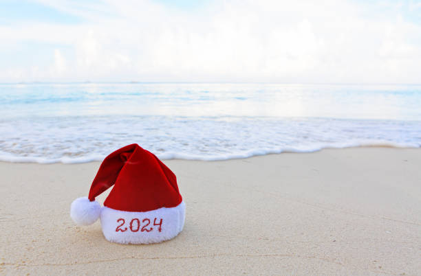 istock New Year 2024 background with Christmas hat on Caribbean sand. 1750431213
