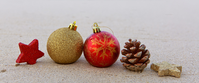 Merry Christmas ball and decorations on the white Caribbean sand.