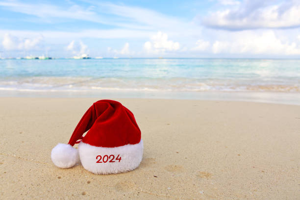 istock New Year 2024 background with Christmas hat on Caribbean sand. 1750432746