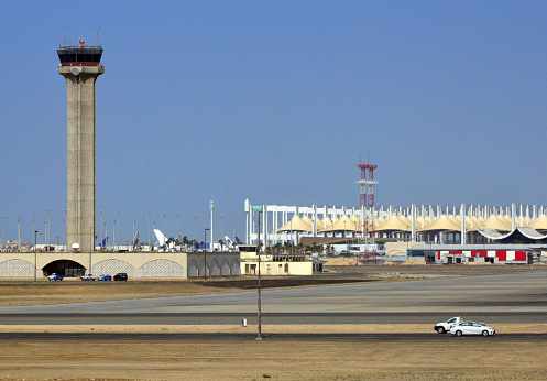 Jeddah, Saudi Arabia: King Abdulaziz International Airport (KAIA) - Control tower and Hajj Terminal, an open building using fiberglass fabric tents suspended from tapering steel pylons,  covers more area (40.5 hectares) than any roof in the world - built for Muslim pilgrims going to Mecca for Hajj or Umrah - Jeddah International Airport - Mecca Region (Tihamah region of the Hejaz) - Al Medinah Munawara road.