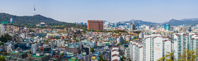 The iconic spire of the Namsan Tower overlooking the crowded high-rise cityscape of central Seoul, South Korea’s vibrant capital city.