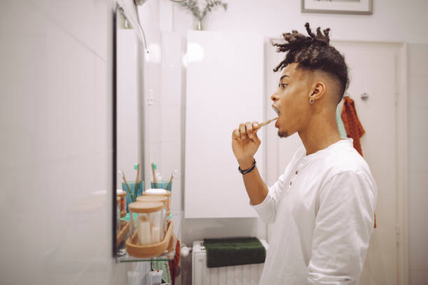 istock At home - young man brushing his teeth 1750445119