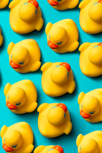 istock Yellow rubber ducks organized on blue background. 1750451783