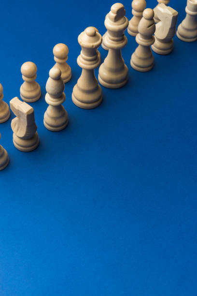 istock Wooden chess figurines on blue background. 1750456378