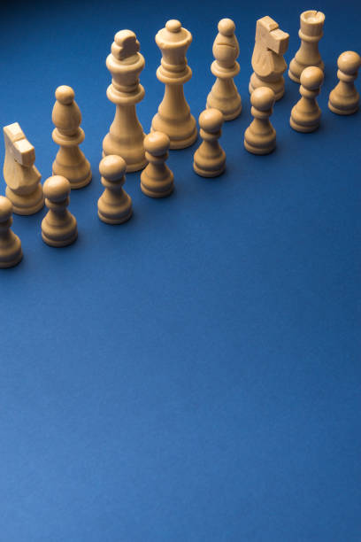 istock Wooden chess figurines on blue background. 1750458563