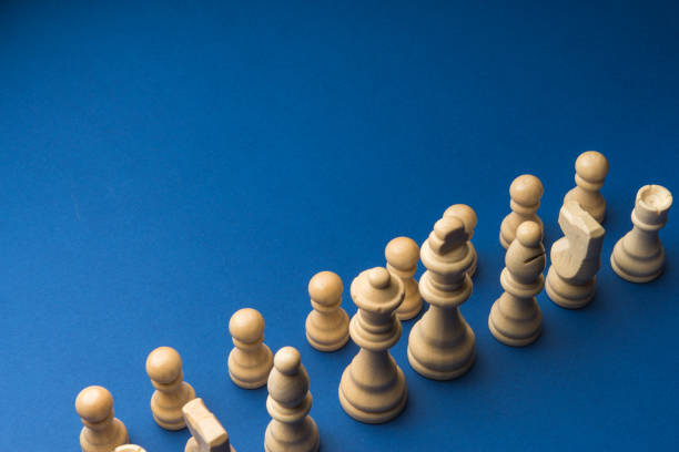 istock Wooden chess figurines on blue background. 1750460774