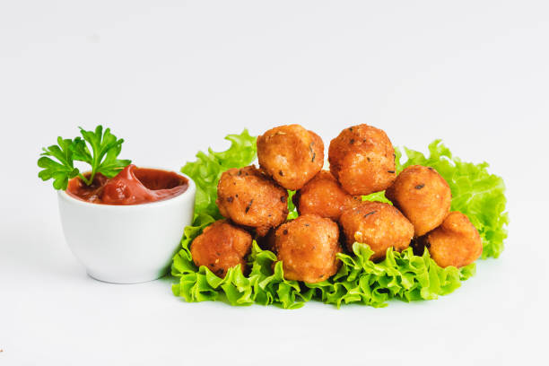 istock Breaded Chicken Inner Fillet with green lettuce leaves on a White Background,Chicken Breaded Raw Meat,Fillet.Breaded chicken nuggets. Fast homemade food at home.Chicken breaded schnitzels.Fast cooking 1750475836